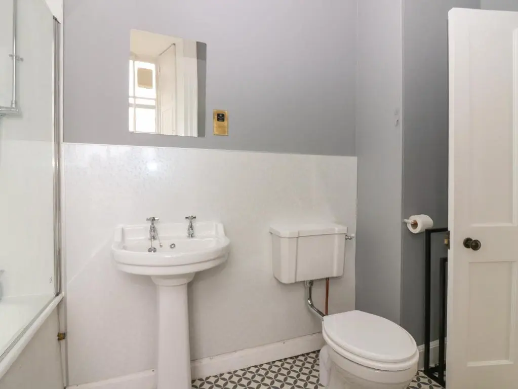 a white bathroom with a sink and a toilet at East Wing - Castle Fraser in Inverurie