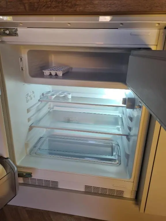 an empty refrigerator with its door open and its door at The Hide in Ullapool