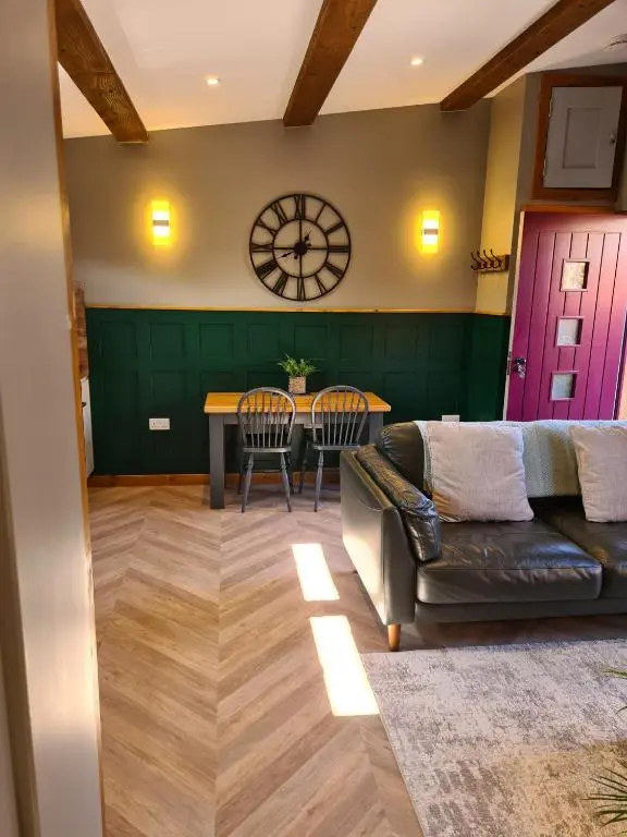 a living room with a couch and a table at The Hide in Ullapool