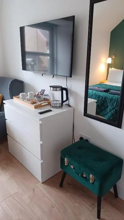 a room with a vanity with a mirror and a bed at Gynack Villa in Kingussie