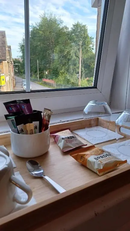 a kitchen counter with a window and a cutting board at Gynack Villa in Kingussie