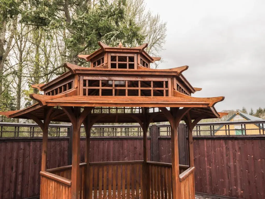 a wooden gazebo on a wooden fence at The Hen House in Beauly
