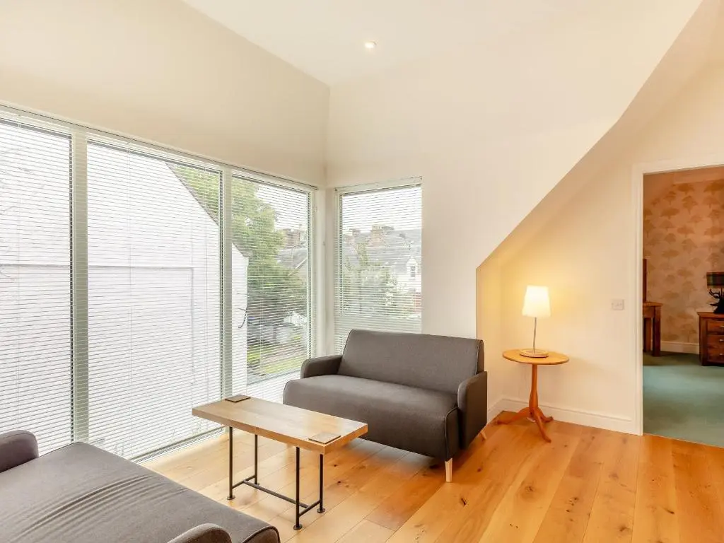 a living room with a couch and a chair at Rose Cottage - Uk39245 in Inverness