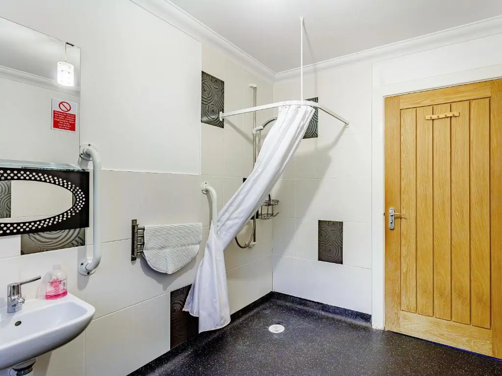 a bathroom with a shower and a sink at Osprey Cottage- Ukc5519 in Boat of Garten