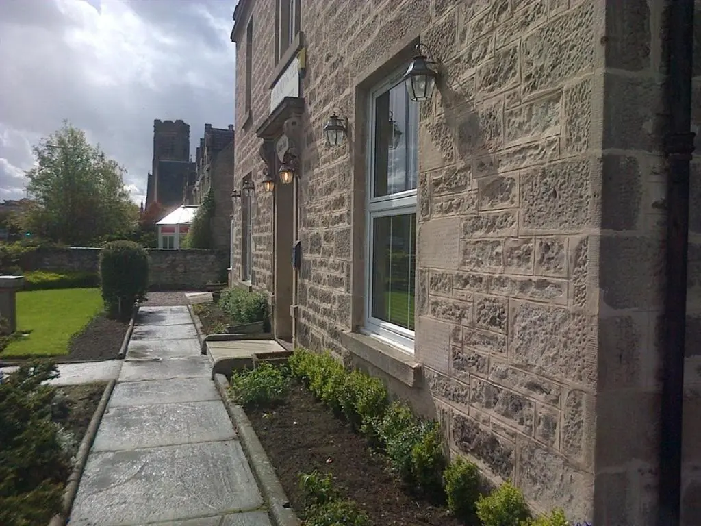 a stone building with a window on the side of it at Aurora Hotel & Italian Restaurant in Nairn