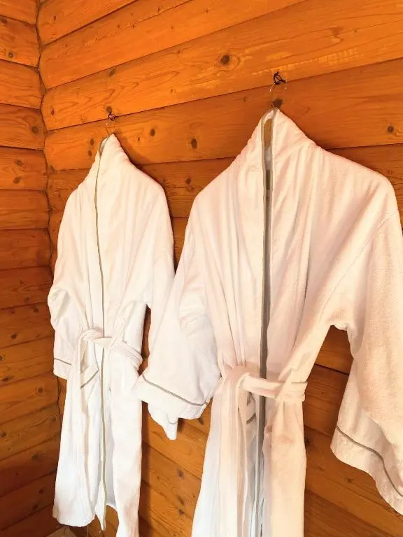 two white robes hanging on a wooden wall at Kaoglen-Stags Suite-Hot tub-Cairngorms- Dog Friendly in Balnald