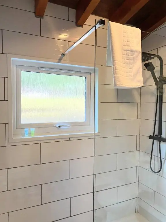 a bathroom with a window and a shower at Kaoglen-Stags Suite-Hot tub-Cairngorms- Dog Friendly in Balnald