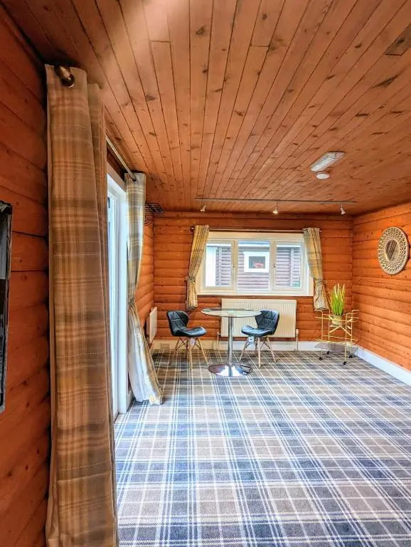 a room with a table and chairs in a house at Kaoglen Doe-Feature Bathroom-Cairngorms-Pets Allowed in Balnald