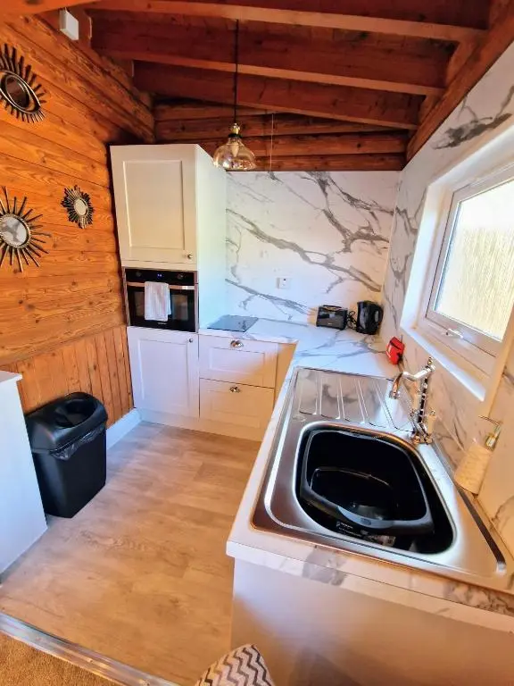 a kitchen with a sink and a counter top at Kaoglen Squirrel Drey-Hot Tub-Pet Friendly-Perth in Balnald