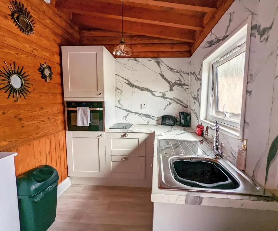 a small kitchen with a sink and a window at Kaoglen Squirrel Drey-Hot Tub-Pet Friendly-Perth in Balnald