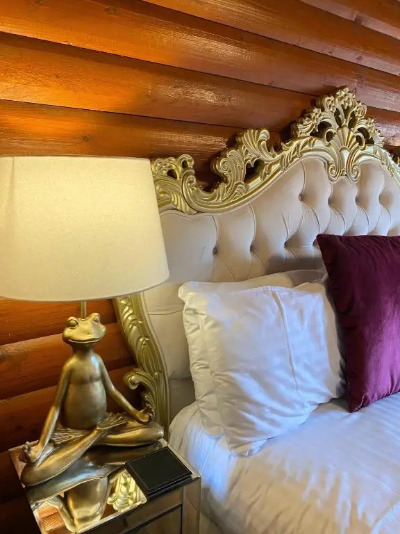 a bed with a lamp on a table next to it at Kaoglen Zen-Feature Bath-Dunkeld-Route 500 in Balnald