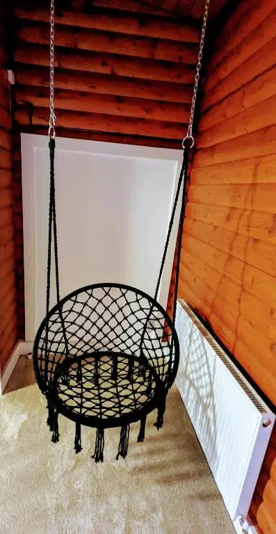 a swing hanging from a wall in a garage at Kaoglen-Spruce-Hot Tub-Forrest Setting-Pet Friendly in Balnald