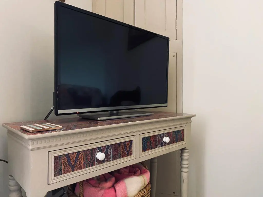 a tv sitting on top of a dresser at Quirky Highland Cottage with Stunning Views in Wester Fearn