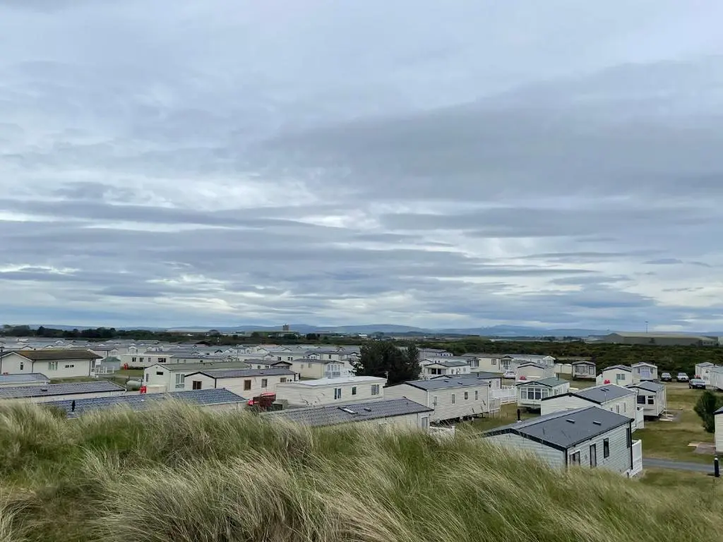 a group of houses sitting on top of a hill at Dune View Caravan in Lossiemouth