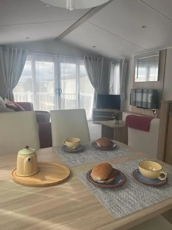 a table with two plates of food on top of it at Dune View Caravan in Lossiemouth