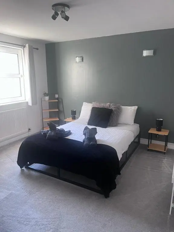 a bedroom with a bed with two teddy bears on it at Stylish apartment in the heart of Inverness in Inverness