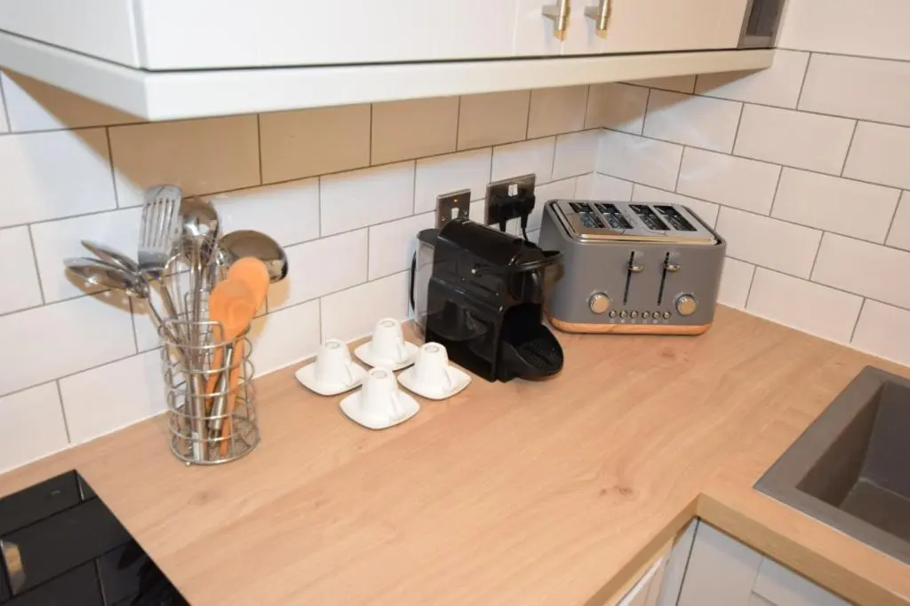 a kitchen counter with utensils on a counter top at Silver Key Apartments III in Inverness