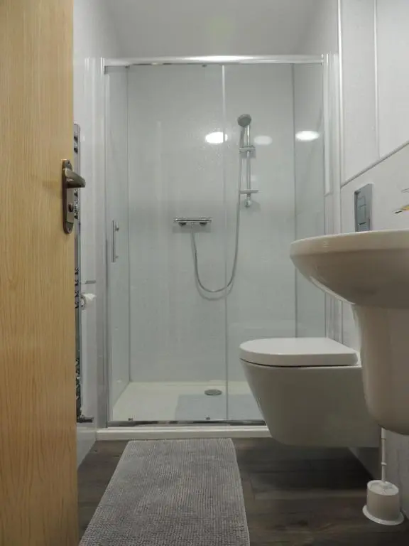 a bathroom with a shower and a toilet and a sink at Braeview Studio in Macduff