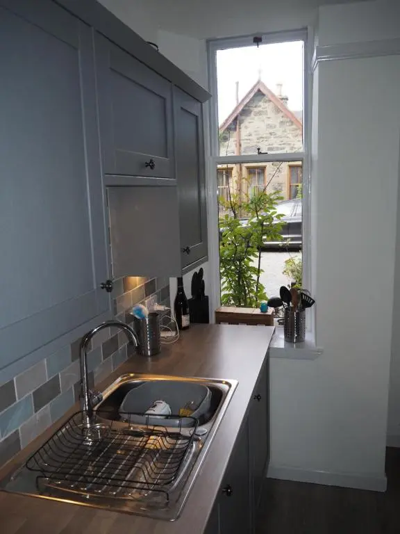 a kitchen with a sink and a window at Uist Cottage in Kingussie