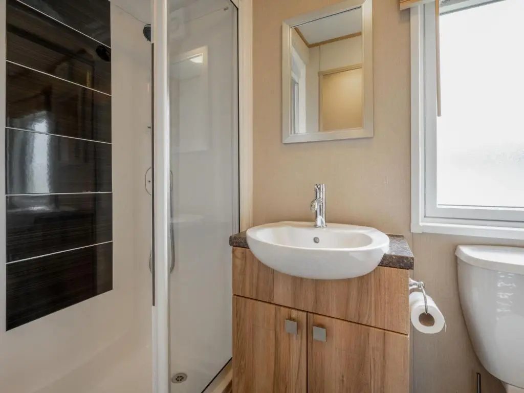 a bathroom with a sink and a shower at Holiday Home Golf View by Interhome in Nairn