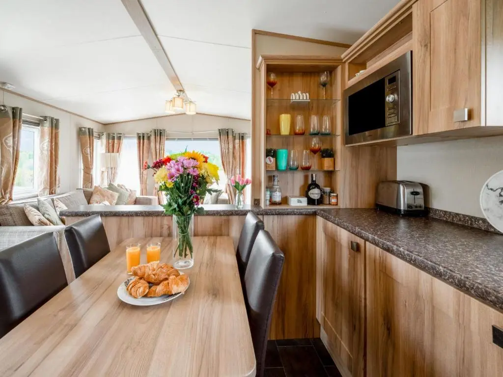 a table in a kitchen with a plate of food on it at Holiday Home Golf View by Interhome in Nairn