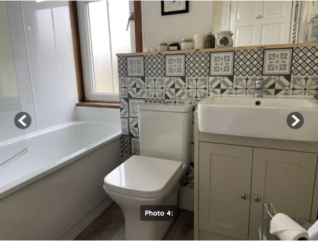 a bathroom with a toilet and a sink and a tub at The Castle Front Nest in Inverness