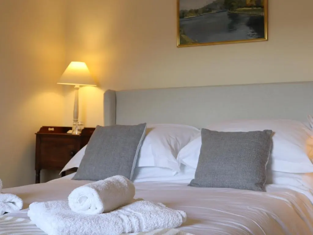 a bedroom with a bed with towels on it at Mains of Orton in Fochabers