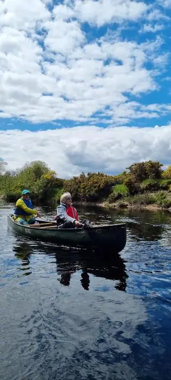 two people in a canoe on a river at The Wee Hoose in Boat of Garten