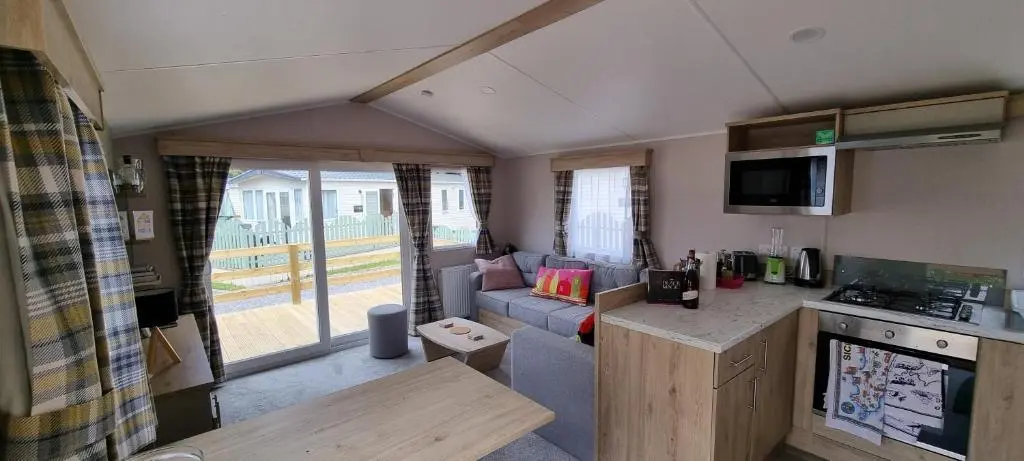 a small kitchen and living room in a caravan at The Wee Hoose in Boat of Garten