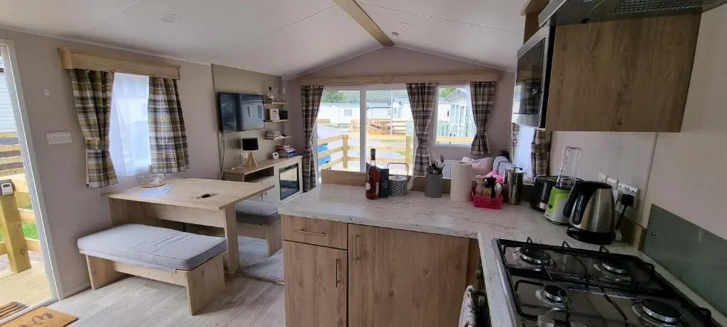 a small kitchen with a table and a stove at The Wee Hoose in Boat of Garten