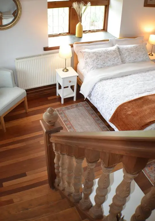 a bedroom with a large bed and a chair at The Tower, Moray Firth Holiday Home in Kinloss