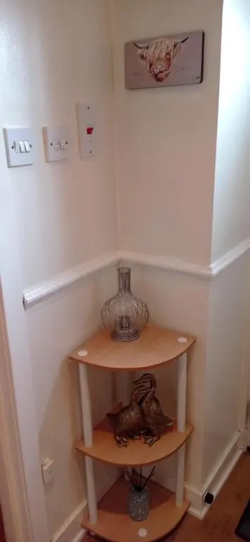 a small shelf in a corner of a room at Isla Way Stays in Keith