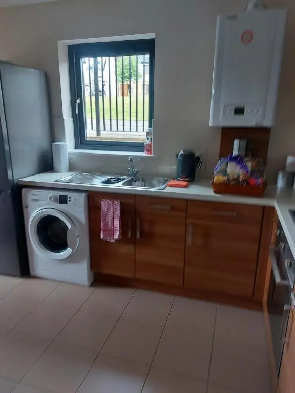 a kitchen with a sink and a washing machine at The Mews in Inverness