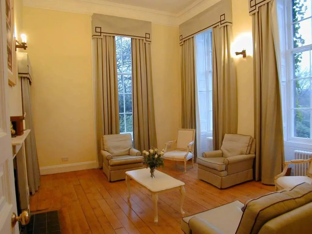 a living room with a couch and chairs and a table at Cortes House in Fraserburgh