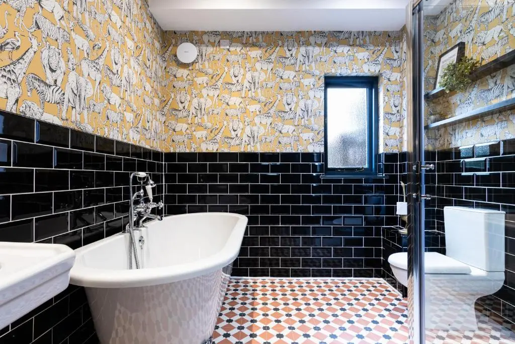 a bathroom with a tub and a sink and a toilet at Ness on the Lane in Inverness