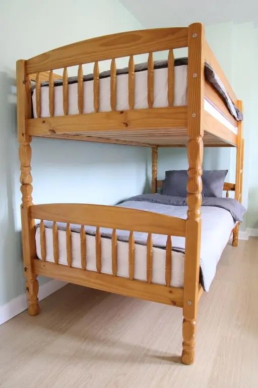 a wooden bunk bed in a room at Aria Lodging Inverness in Inverness
