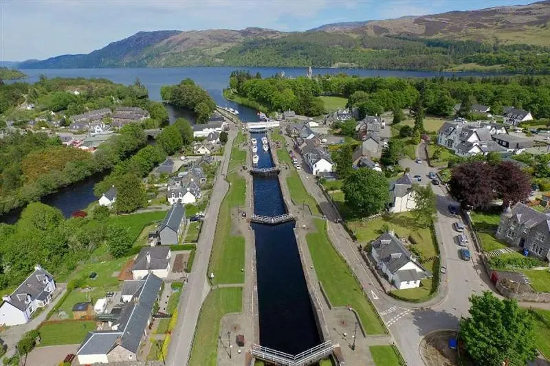 an aerial view of a town with a canal at The Cabin, Stronua. A beautiful 1 bedroom cabin. in Fort Augustus
