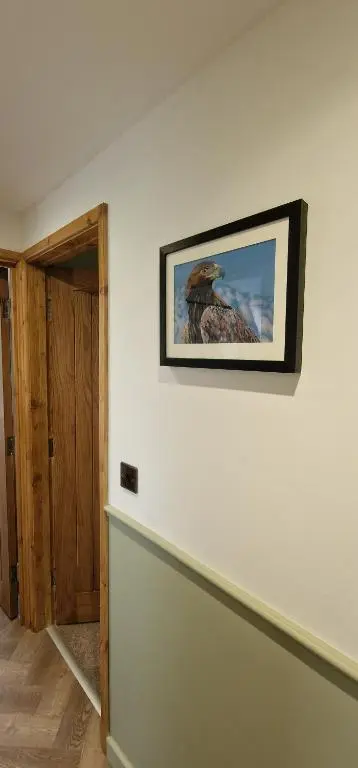 a room with a picture hanging on the wall at Bonnie Lodge-Lochside Location with Hot Tub in Invergarry