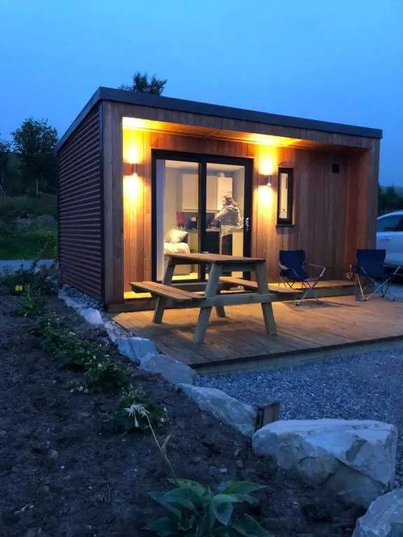 a small cabin with a picnic table in front of it at Ben Klibreck, Ben Hope, Ben Hee in Torroboll