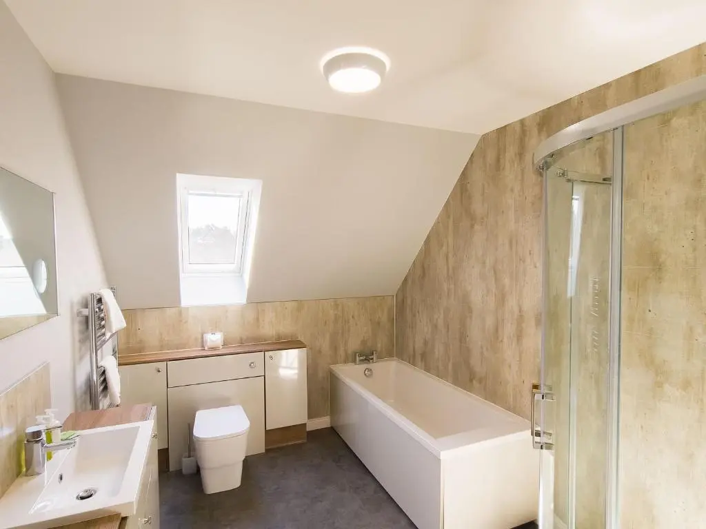 a bathroom with a tub and a toilet and a sink at Braeside - Family home in Nethy Bridge in Nethy Bridge