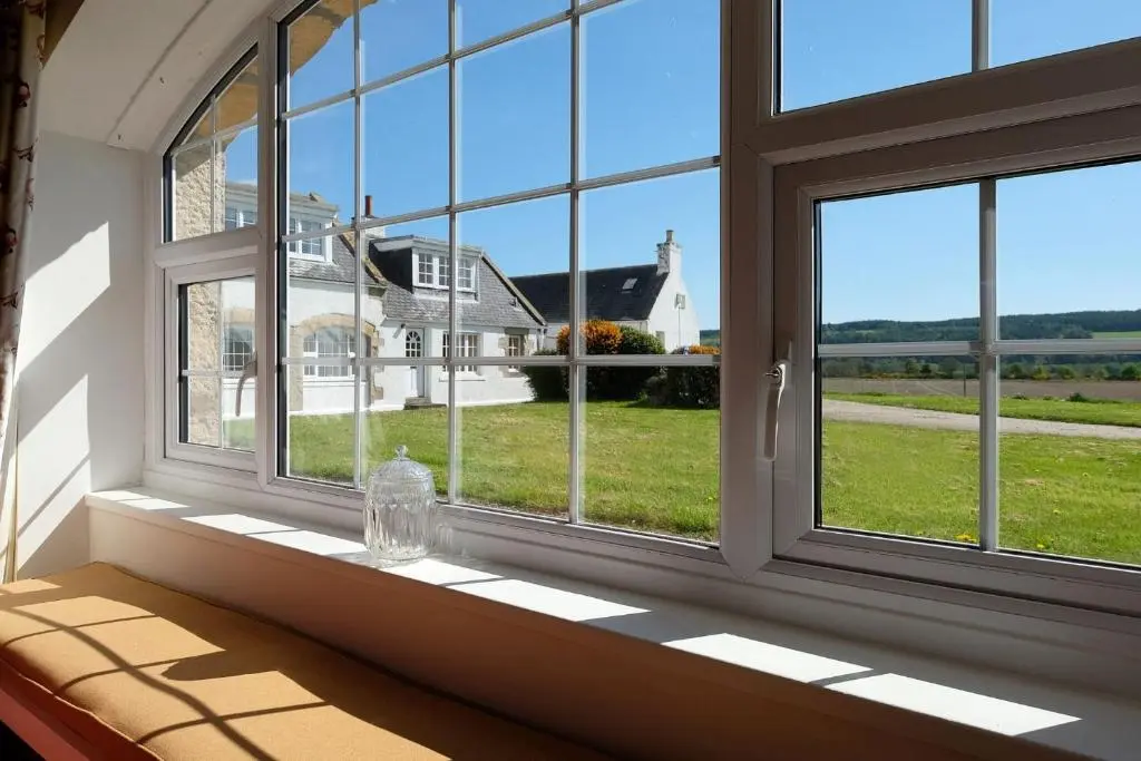 a window seat with a view of a house at Bruntlands Steading in Fochabers