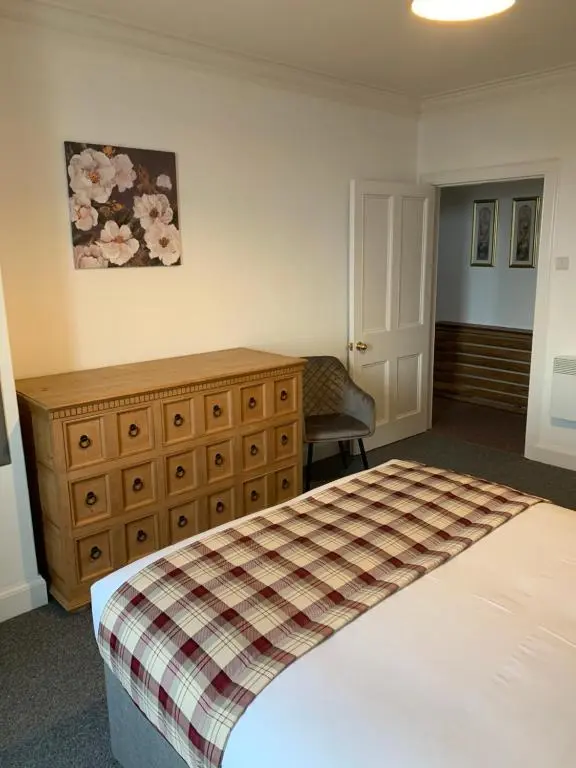 a bedroom with a bed and a dresser at Caithness Stone house in Wick