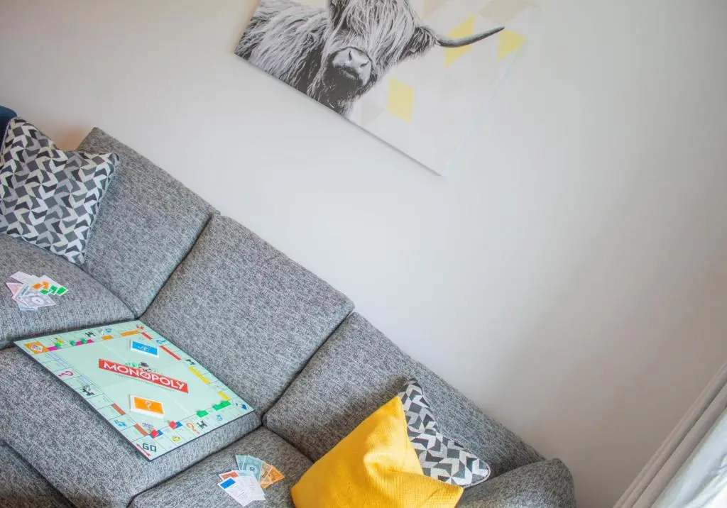 a book sitting on a couch in a living room at 10 Bynack House in Aviemore