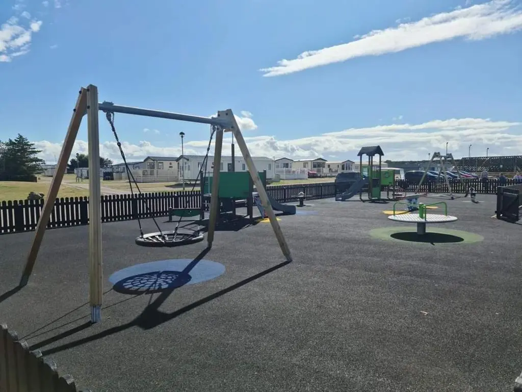 a group of swings in a playground at Aurora Way 81 in Lossiemouth