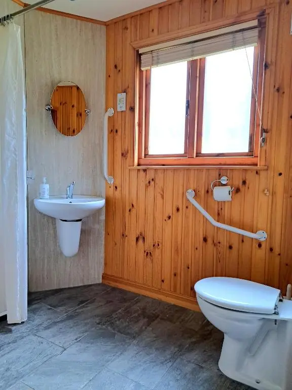 a bathroom with a toilet and a sink at Plodda Lodge at Lochletter Lodges in Drumnadrochit