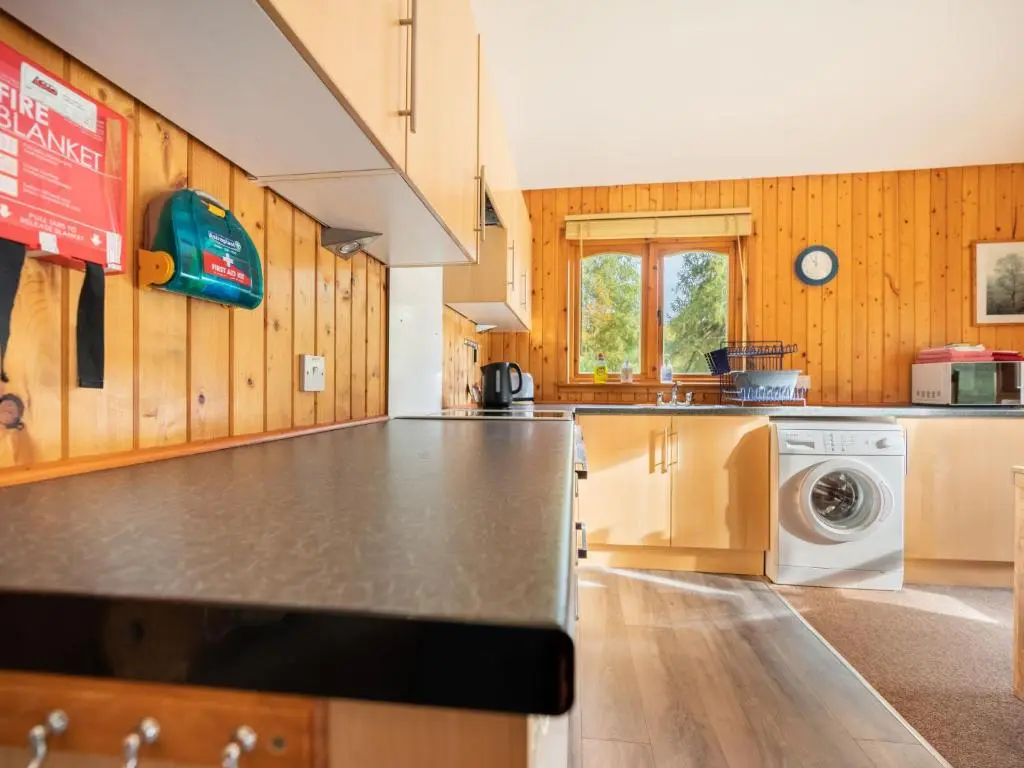 a kitchen with a washer and dryer at Guisachan Lodge at Lochletter Lodges in Drumnadrochit