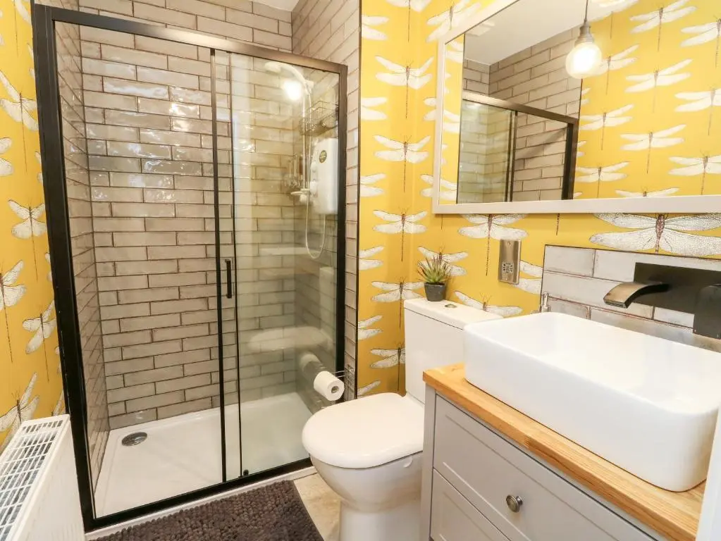 a bathroom with a shower and a toilet and a sink at Ulla Dhu in Nethy Bridge