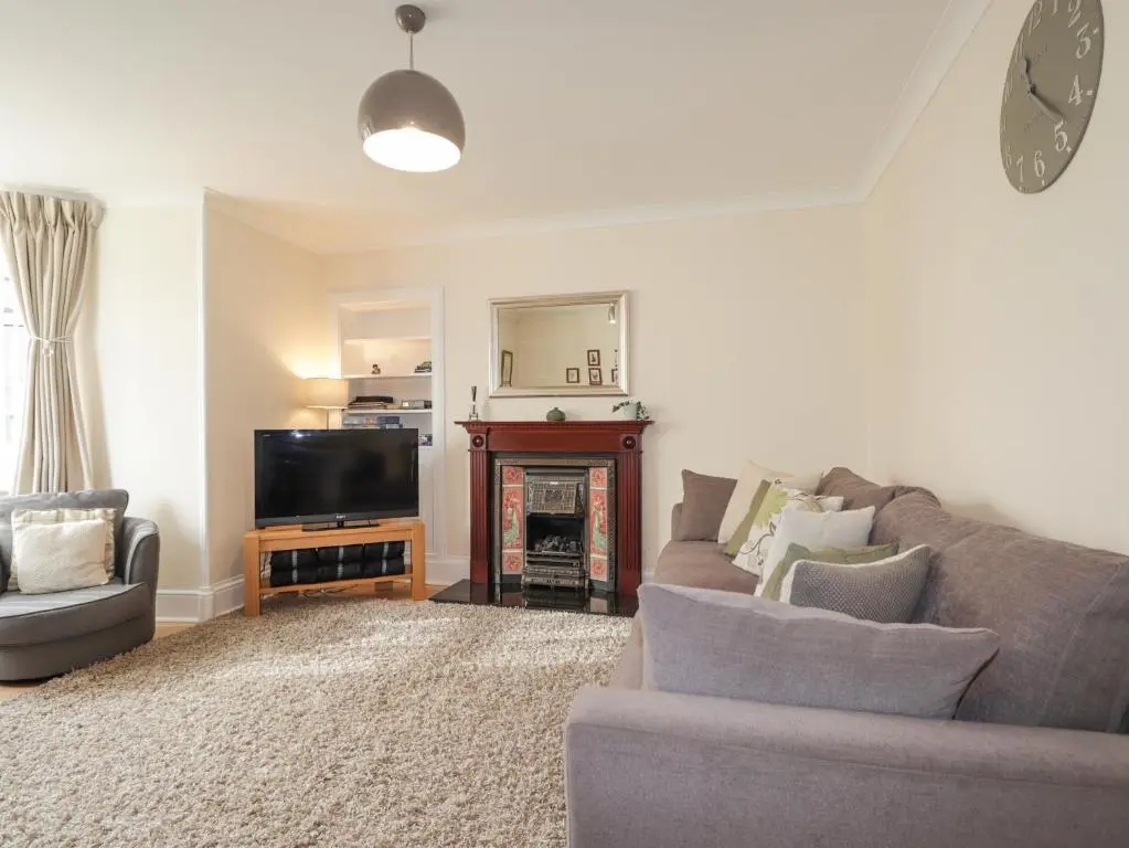 a living room with a couch and a television at Ballinreich in Inverness