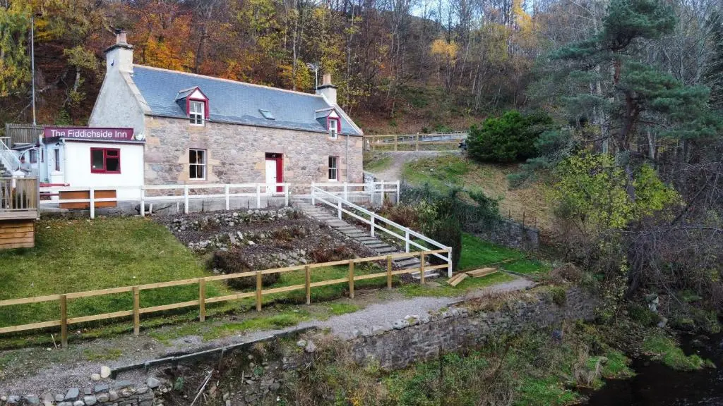 a house with a garden in front of it at The Fiddichside Inn in Aberlour