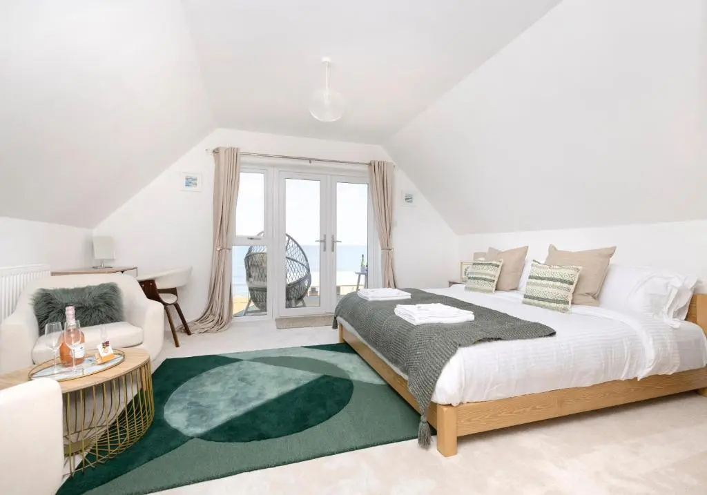 a bedroom with a large bed and a green rug at Aurora House Hot Tub & Sea View in Buckie